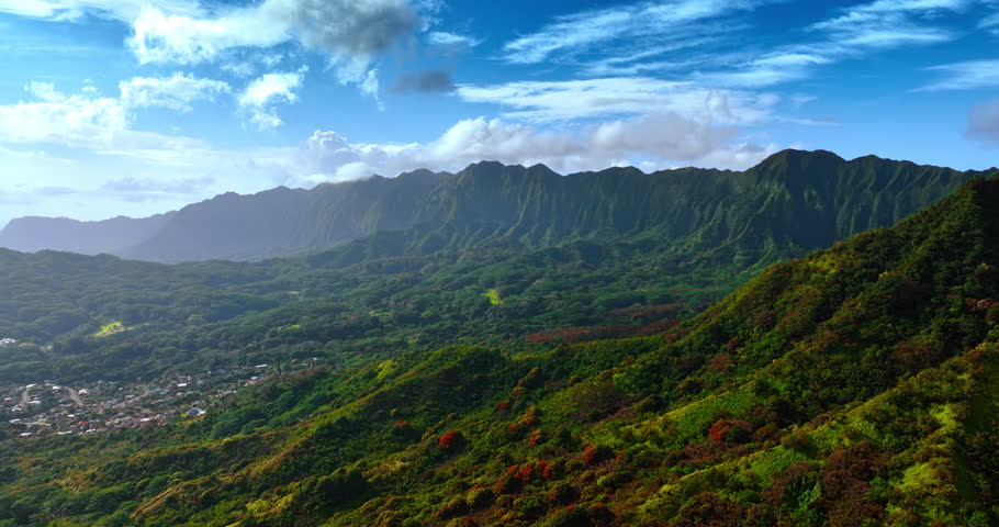 Bright sun lighting the stunning Koolau Range in the Oahu Island, Hawaii. Spectacular nature landscape with some urban area. Top view.