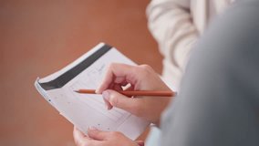 Closeup view of project manager pointing at trouser design sketch on white paper sheet while holding pencil during active teamwork planning creative clothing development session - Powered by Shutterstock - Get 15% off with code: PIKWIZARD15