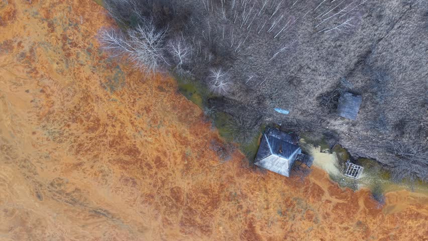 Drone scenic footage of the nature pollution and water contamination of the copper mine exploitation in Geamana, near Rosia Montana, Romania, Europe