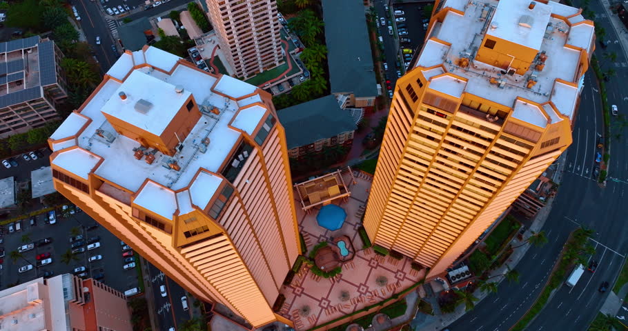 Tops of the high-rise similar buildings. Drone footage down along the buildings. Honolulu, Hawaii, USA.