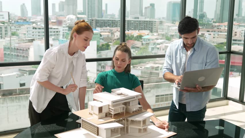 Smart architect team discussion about house design while handsome male worker present idea by using laptop. Group of professional engineer sharing, brainstorming design. Business design. Tracery