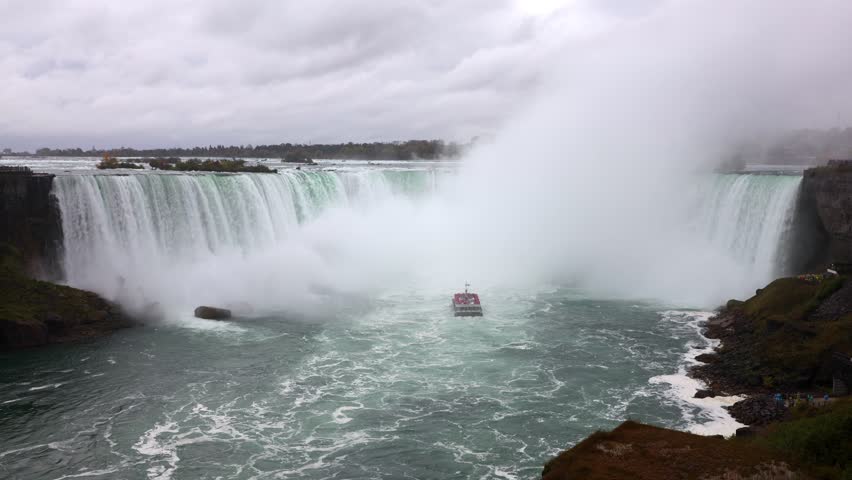 Niagara Falls with tour boat near Horseshoe Falls on a cloudy day in Ontario, Canada
