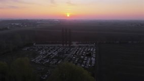 Aerial view of a cemetery at sunrise in spring, with tombstones adorned with flowers on a misty morning. - Powered by Shutterstock - Get 15% off with code: PIKWIZARD15