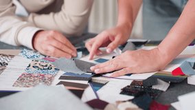 Fashion designers carefully checking textures and qualities of different colorful fabrics spread across table during material selection session, emphasizing creativity and attention to textile detail - Powered by Shutterstock - Get 15% off with code: PIKWIZARD15