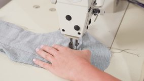 Hand view of tailor removing material from needle, cutting thread, ensuring seamless finish, showing precise garment craftsmanship, focusing on technique, neat edges, quality results - Powered by Shutterstock - Get 15% off with code: PIKWIZARD15