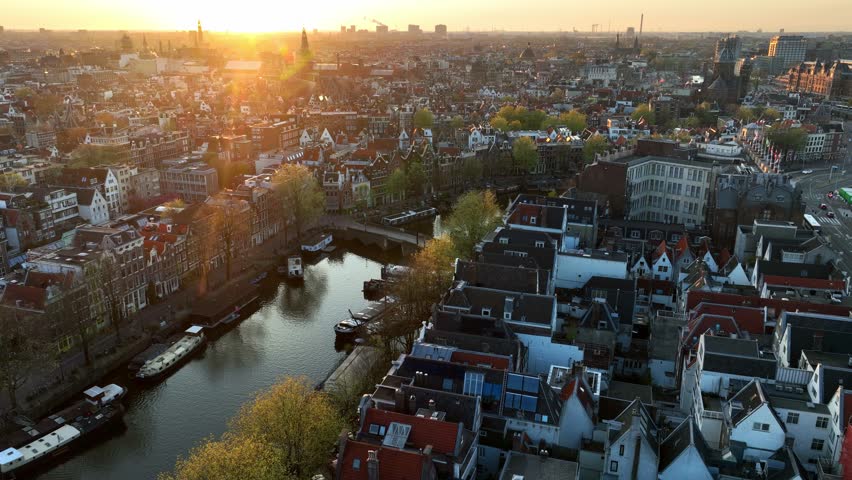 Amsterdam aerial view at sunset, drone shot of the capital of the Netherlands in spring, travel in Netherlands, old town of Amsterdam