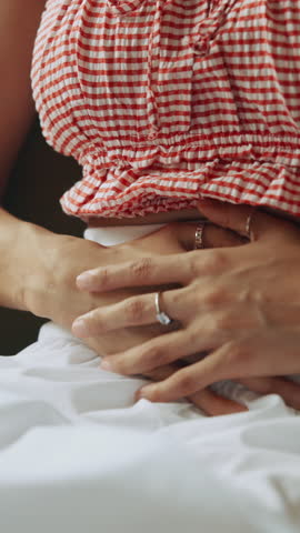 Woman, pain and hands with stomach ache for indigestion, gastrointestinal disease or reflux at home. Sick, female person or belly cramp with nausea, illness or menstruation for period cycle at house