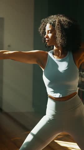 Warrior pose, yoga and woman in apartment for fitness, balance and calm with stretching in kitchen. Health, wellness and African yogi person for workout, exercise and holistic self care at home