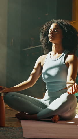 Calm, meditation and woman in lotus pose in home for relax, zen or mental health in living room. Wellness, inner peace and female person with yoga for mindfulness, energy or spiritual growth in house