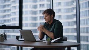 Businessman talking at online negotiations sitting modern office interior. Smiling professional discussing project by video call at workplace. Man manager speaking in laptop webcam at virtual meeting. - Powered by Shutterstock - Get 15% off with code: PIKWIZARD15