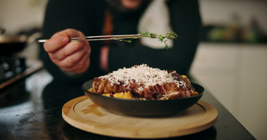 Hands, person and herbs with food in kitchen for hospitality industry, fine dining and nutrition cuisine. Chef, garnish and steak for catering service, healthy meal and lunch presentation of wellness