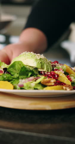 Cooking, salad and chef with plate of food for culinary, meal prep and dinner in restaurant. Kitchen, catering and person with closeup of ingredients for nutrition, gourmet dish and cuisine recipe
