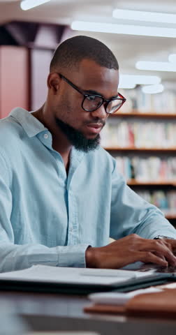 Black man, student and research with laptop at library for project, assessment or university assignment. Male person, academic learner or browsing with computer for literature paper, essay or thesis
