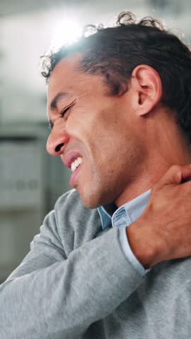 Stress, uncomfortable and businessman in office with shoulder pain, injury or burnout. Hurt, fibromyalgia and male person with muscle sprain for arthritis, bad ergonomics or poor posture in workplace