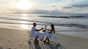 A couple in love enjoys a delightful dinner on the ocean beach - Powered by Shutterstock - Get 15% off with code: PIKWIZARD15