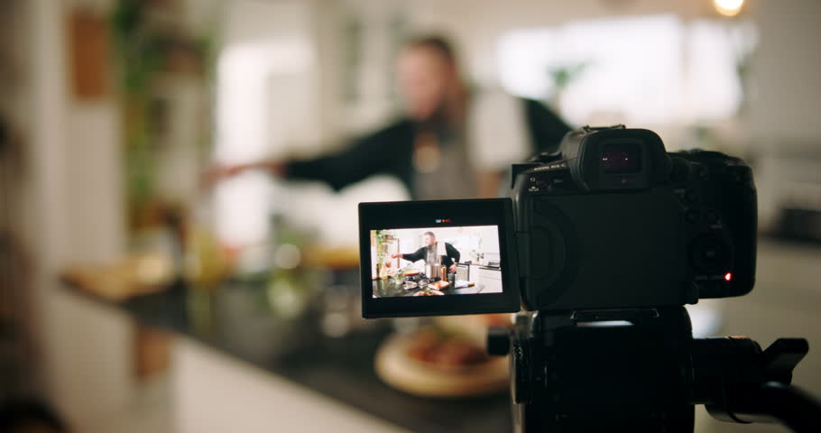 Camera, cooking and man in kitchen with meal, dinner or recipe online with content creation. Food, recording and male chef influencer with equipment for live streaming with diet advice in home.