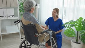 Asian caring caregiver look after senior woman patient at nursing home. Elderly grandmother in wheelchair receiving physical therapy with support from female nurse therapist during the therapy session - Powered by Shutterstock - Get 15% off with code: PIKWIZARD15