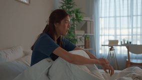 Depressed Asian young woman feel upset while sitting on bed in bedroom. Frustrated stressed girl feeling sad and headache with life problem and financial in house. Health care and Expression Concept. - Powered by Shutterstock - Get 15% off with code: PIKWIZARD15