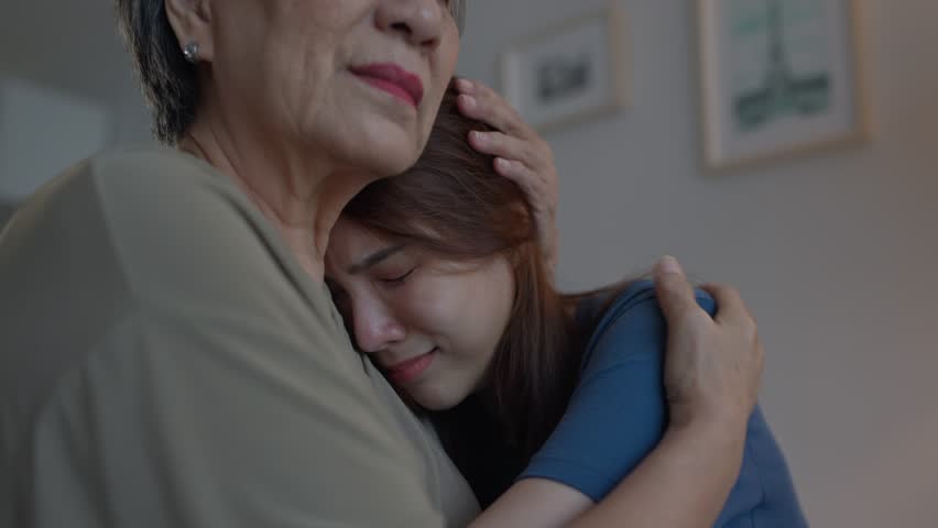 Asian elderly mother comforting upset daughter crying for life problem. Caring senior mature mom support, consoling and understand empathy to stressed young woman in tears at home. Family relationship - Powered by Shutterstock - Get 15% off with code: PIKWIZARD15