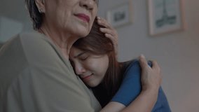 Asian elderly mother comforting upset daughter crying for life problem. Caring senior mature mom support, consoling and understand empathy to stressed young woman in tears at home. Family relationship - Powered by Shutterstock - Get 15% off with code: PIKWIZARD15
