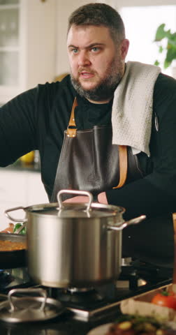 Chef, live streaming and man in kitchen for cooking dinner, recipe tutorial and meal preparation in home. Culinary influencer, sauce and person with food, camera and ingredients for social media