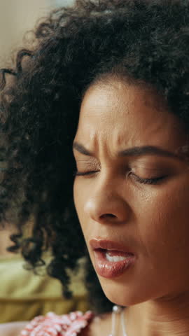 Sneeze, tissue and sick with black woman for flu season, pneumonia infection and illness on sofa. Hayfever, blowing nose and allergy with person in living room in home for recovery, disease and cold