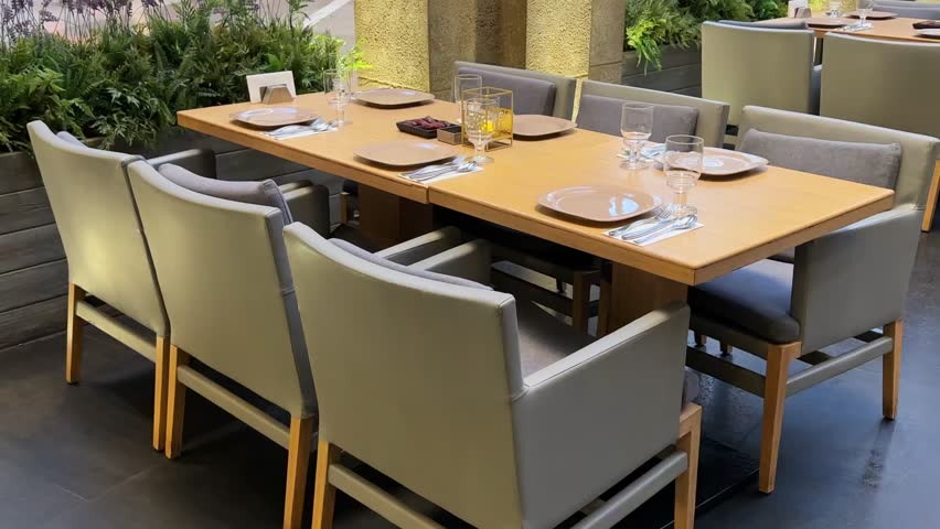 Experience a sophisticated dining setup in 4K, featuring a sleek, modern table arrangement perfect for upscale restaurant scenes and lifestyle content creation.