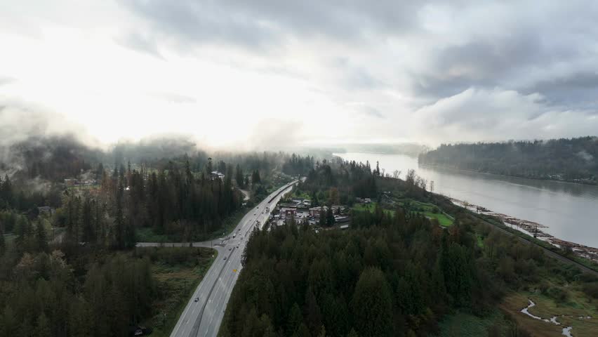 Foggy Highway and River Through a Forest in British Columbia, Canada