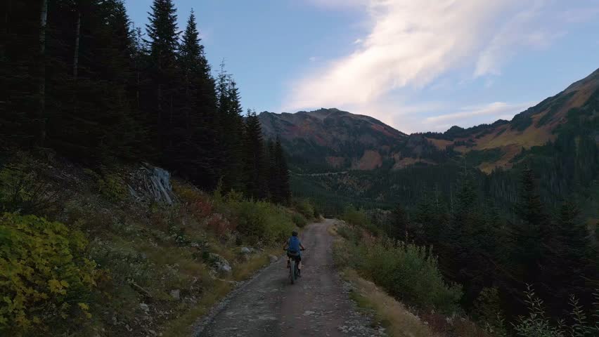 Mountain Biker on Scenic Trail in British Columbia at Sunset