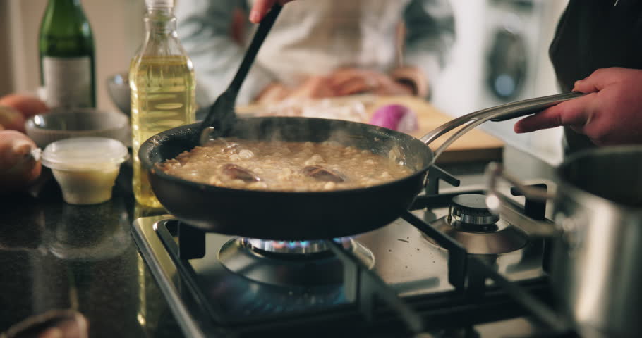 Hands, chef and stirring food in kitchen for cooking sauce, meal preparation and risotto recipe. Person, vegetables and rice dish with culinary skills, nutrition dinner and gourmet cuisine at house