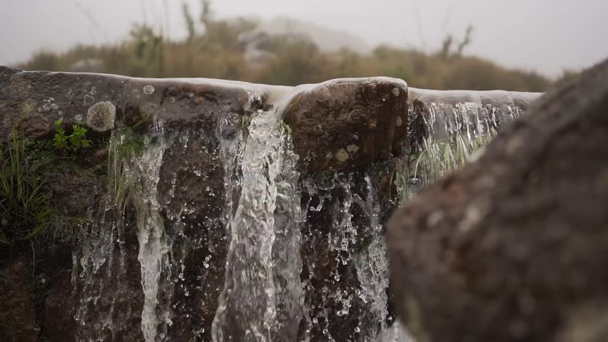 Stepping over a waterfall in Itatiaia, Minas Gerais, Brazil, in nature