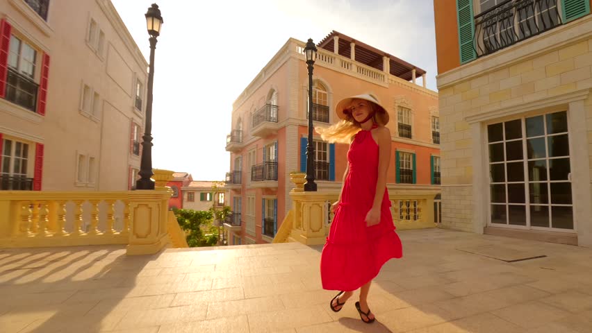 Cinematic shot of tourist in Vietnamese hat walking through Sunset Town on Phu Quoc Island, Vietnam. Concepts of Vietnam travel, culture, and adventure.