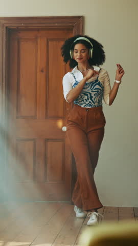 Woman, energy and dancer with headphones in home for streaming music, radio sound and groovy album. African person, rhythm and audio technology for weekend playlist, feel good track and entertainment