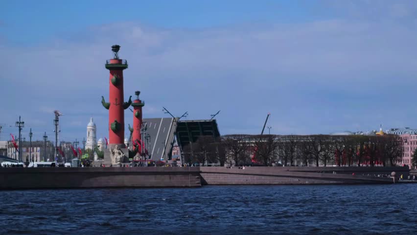 Saint Petersburg, Russia, 14.04.2024. A city with a large red building and a tall red tower. The water is calm and the sky is clear