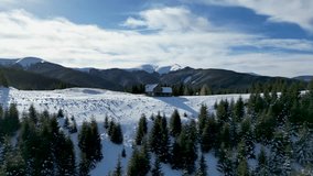 A drone footage of an old cabin on a snowy hiking trail in the Bucegi Mountains during the winter on a sunny day in Brasov, Romania - Powered by Shutterstock - Get 15% off with code: PIKWIZARD15