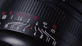 Close up: film photography lens shifts focus. Moving distance scale on vintage film photography lens during focusing. Fingers adjusting DSLR Lens - Powered by Shutterstock - Get 15% off with code: PIKWIZARD15