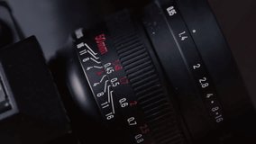 Close up: film photography lens shifts focus. Moving distance scale on vintage film photography lens during focusing. Fingers adjusting DSLR Lens - Powered by Shutterstock - Get 15% off with code: PIKWIZARD15