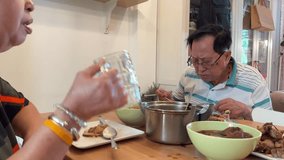 The East Asian senior couple is eating lunch together in the dining room. - Powered by Shutterstock - Get 15% off with code: PIKWIZARD15