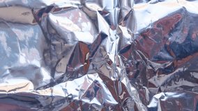 Crumpled reflective shiny gift wrapping material texture stop motion animated background - Powered by Shutterstock - Get 15% off with code: PIKWIZARD15