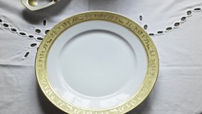 White gloved waiter places Gilded china soup bowl at posh banquet table - Powered by Shutterstock - Get 15% off with code: PIKWIZARD15