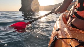 Kayaking Sunset Sea - Kayaking under a beautiful sunset with large rock formations in the background. - Powered by Shutterstock - Get 15% off with code: PIKWIZARD15