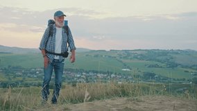 Joint Health, Physiotherapy, Resilient Aging. Senior Man Hikes Through Mountains While Managing Knee and Back Pain. A Real Moment of Strength, Movement Therapy, and Health Support in Later Life - Powered by Shutterstock - Get 15% off with code: PIKWIZARD15
