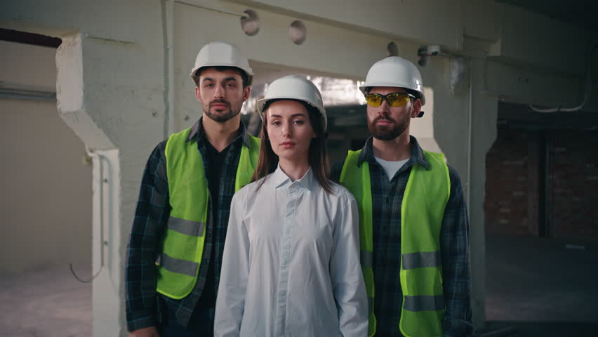 Confident glad Caucasian workers males architects builders men team coworkers controller woman crossing arms cooperation inspector looking at camera mechanics female smiling in construction teamwork