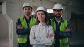 Confident glad Caucasian workers males architects builders men team coworkers controller woman crossing arms cooperation inspector looking at camera mechanics female smiling in construction teamwork - Powered by Shutterstock - Get 15% off with code: PIKWIZARD15