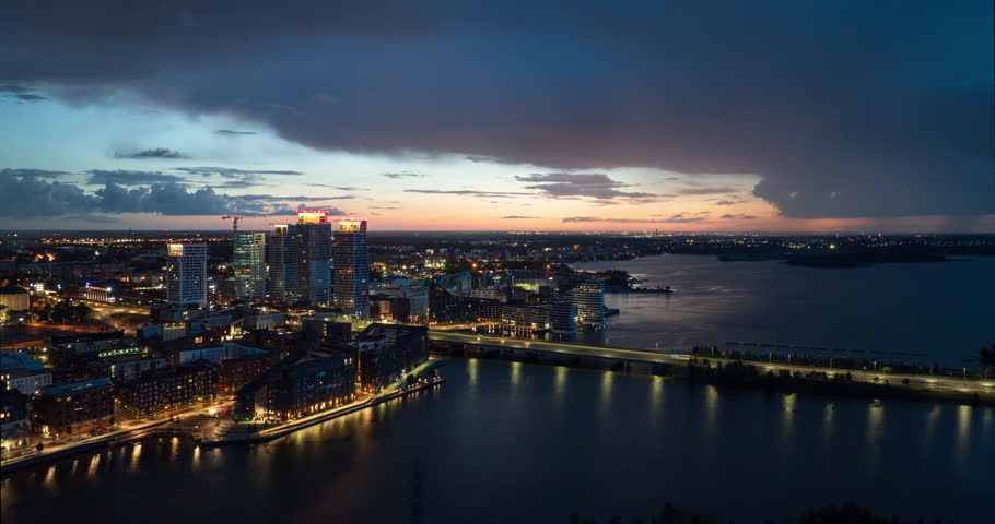 Aerial hyperlapse around the illuminated Kalastama district of Helsinki, dusk