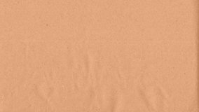 Beige kraft paper noise texture 4K stop motion video. Aged old page overlay effect background loop animation. Vintage paper texture with crease, stain, grain, dust particles. Empty animated backdrop  - Powered by Shutterstock - Get 15% off with code: PIKWIZARD15