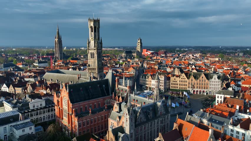 Bruges aerial view in the morning, famous Belgian historical city drone shot, tourism in Belgium, gothic cathedral in the Market square in Bruges