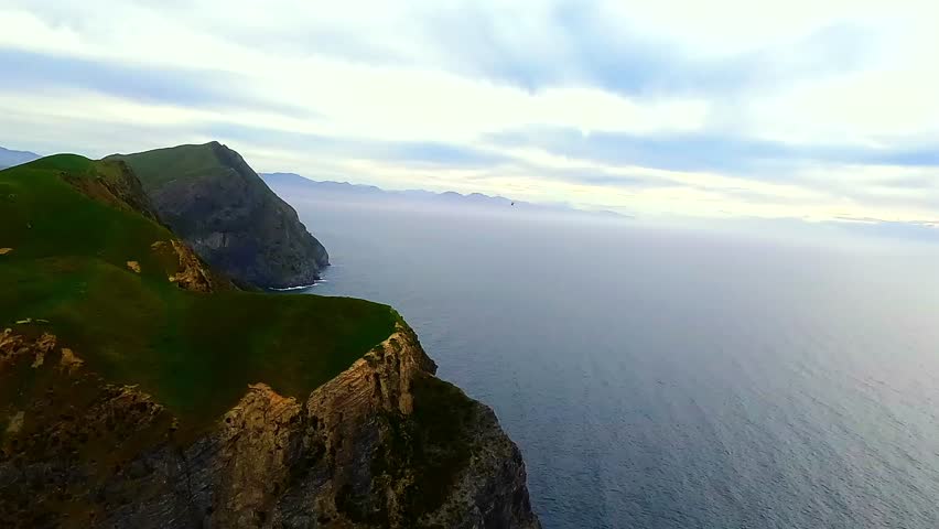 Helicopter Aerial flying over the massive cliffs of Rangitoto ki te Tonga, D'Urville Island, Marlborough sounds, New Zealand