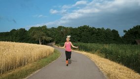 Woman in her 40s does workout outdoors in nature at sunrise on a sunny day.  Blonde woman with a fit body jumping rope on a countryside alley in nature
 - Powered by Shutterstock - Get 15% off with code: PIKWIZARD15