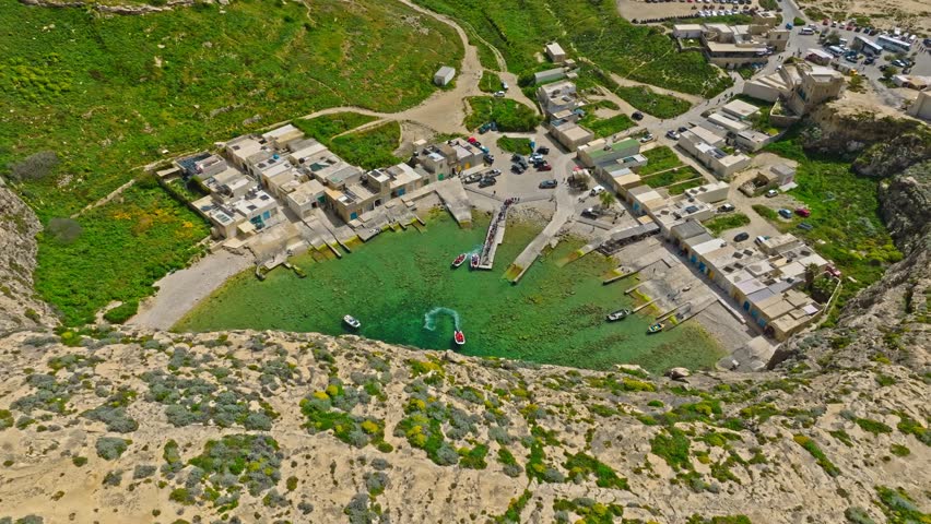 Touristic boat goes inside the cave on the Inland Sea in Gozo, Malta